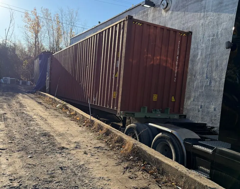 40 ft shipping container on its trailer alongside our warehouse