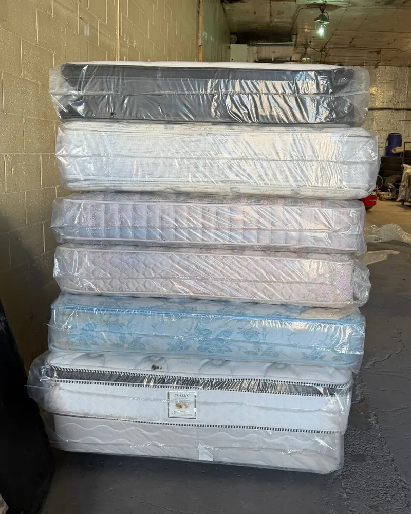 Stack of six mattresses protected by clear plastic